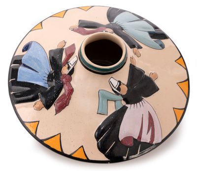 a small vase with a painting on it sitting on a table