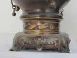 a large metal bowl with a handle on a stand