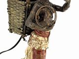 statue of a man with a basket and a monkey on his back