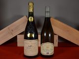 two bottles of wine sitting next to each other on a table