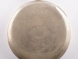 an old silver pocket watch with a chain on a white background