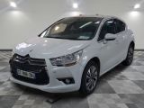 la voiture blanche est garée sur un sol en damier dans le garage