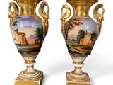 pair of antique vases with painted scenes on them on a white background