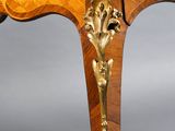 a wooden table with a gold decoration on it