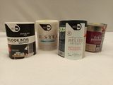 several cans of paint are lined up on a white surface