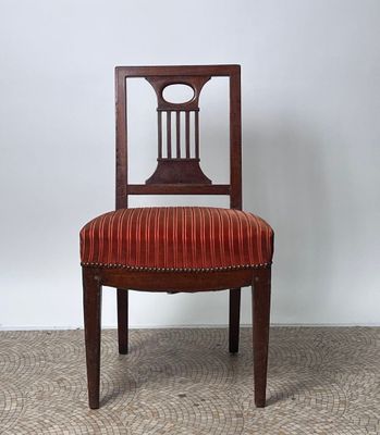 a wooden chair with a red upholstered seat