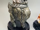 two figurines of animals that are next to each other