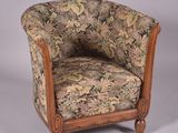 a chair with a floral upholstered back and a wooden frame