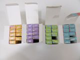 four boxes of chocolate sitting next to each other on a table