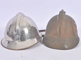 two helmets sitting next to each other on a white surface