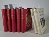 several red books are lined up in a row next to each other