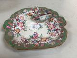 une assiette munie d'une anse et décorée de fleurs