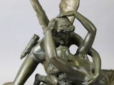 a bronze statue of a man and a woman on a horse