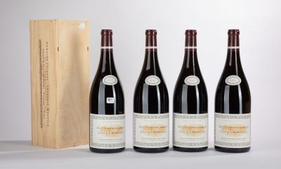 three bottles of wine are lined up in front of a wooden box