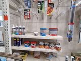 a shelf of paint and other items in a store