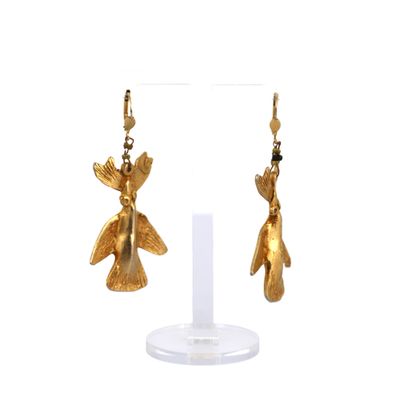 a pair of gold earrings with a bird on it