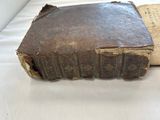 an old book sitting on top of a white table