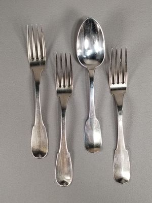 four forks and a spoon on a table
