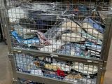 a metal cart with many items in it in a warehouse