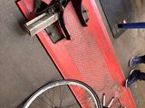 a man working on a bike in a garage