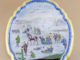 an image of a decorative plate with a painting of people on it