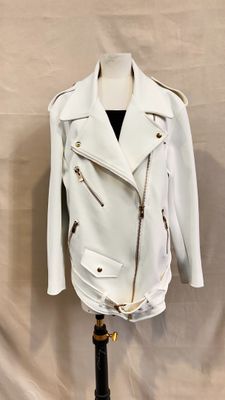 white leather jacket on a mannequin stand on a white background