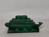 a green boat that is sitting on top of a table