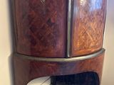 a cabinet that is sitting in the corner of a room