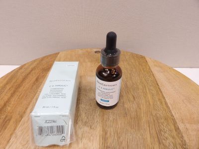a bottle of liquid sitting on a table next to a box of medicine