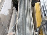 a pile of metal pipes sitting on top of a pile of rubble