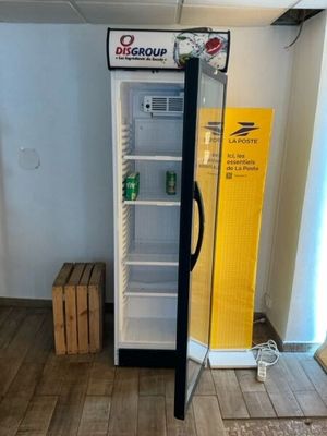 an image of a refrigerator in a room with wood flooring
