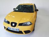 a yellow car that is parked in a white room