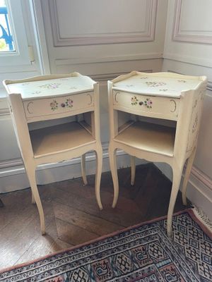 two white tables with drawers on them in a room