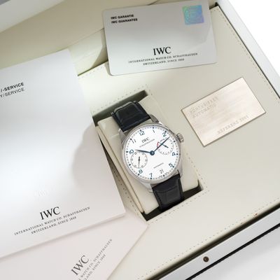 une boîte sur laquelle se trouvent une montre et une carte de visite