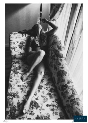 black and white photograph of a woman laying on a couch