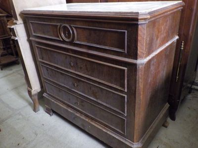 a chest of drawers with a marble top in a room