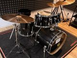 a drum set up in a recording studio with a microphone
