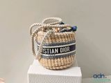 a basket bag with a blue and white stripe on it
