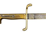 a close up of a knife with a gold handle on a white background