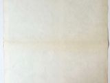 an old piece of paper sitting on top of a wooden table