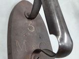 a heart shaped iron hook with the number 3 on it