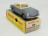 a toy car on top of a box on a white surface