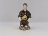 a figurine of a man sitting on a rock