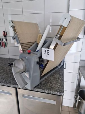 a kitchen counter that has a bunch of knives on top of it