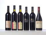 several bottles of wine are lined up on a table