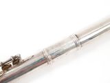 a flute that is sitting on a white surface