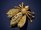 a gold and diamond bee broochle