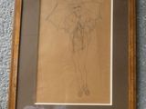 dessin représentant une femme tenant un parapluie, encadré et posé sur un tapis