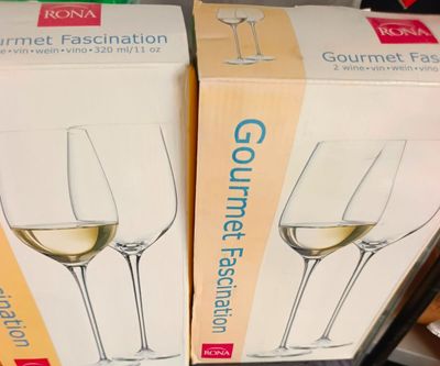 two boxes of wine glasses sitting on a table