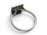 an image of a ring with a black stone in it